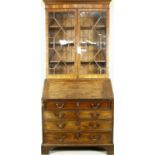 A Georgian mahogany two section bureau bookcase with upper astragal glazed top above fall front