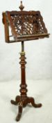 A mid 19th century duet stand with fret cut adjustable sheet holders on adjustable brass column with