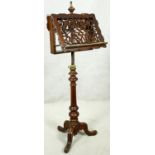 A mid 19th century duet stand with fret cut adjustable sheet holders on adjustable brass column with