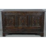 A 17th century carved oak coffer fitted with base drawers on shaped bracket feet. H.84 W.138 D.52cm