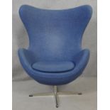 After Arne Jacobsen (1902-1971) Egg chair in blue upholstery and rise and fall action on four
