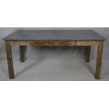 A dining table from reclaimed timbers with metal faced top on square supports. H.76 L.170 W.93cm