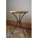 A wrought metal conservatory occasional table with faux stone mosaic top. H.54 Dia.40cm
