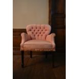 An early 20th century bedroom armchair in deep buttoned upholstery on square tapering supports. H.83