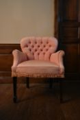 An early 20th century bedroom armchair in deep buttoned upholstery on square tapering supports. H.83