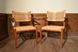 A pair of mid century Danish teak armchairs by Eric Worts with woven cane backs and seats. H.80 W.50