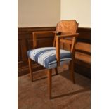 A Continental Art Deco walnut armchair with burr walnut back in striped upholstery on tapering