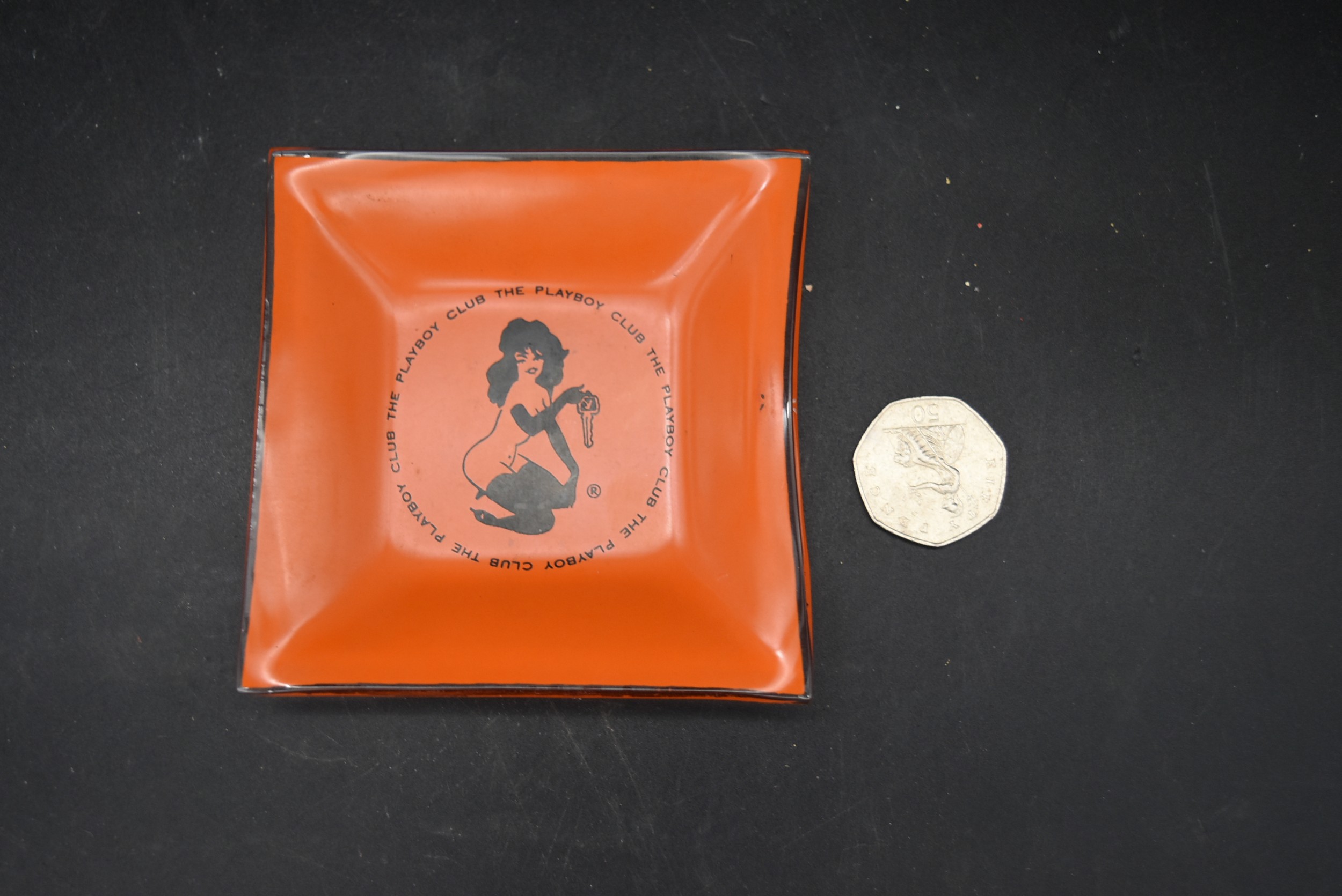 A vintage glass Playboy Club ashtray, marked The Playboy Club with original logo. L.10 W.10cm