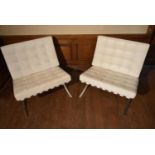 After Ludwig Mies van der Rohe, a pair of Barcelona chairs in white leather upholstery on chrome