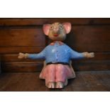 A vintage fibreglass seated figure of a cartoon pig. H.60 W.80 D.30cm