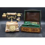 An alabaster and brass telephone in the antique style and a vintage green telephone cased in a