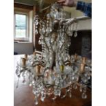 A large ten branch gilt metal and glass chandelier with cut crystal drops. H.100cm Dia.74cm (some