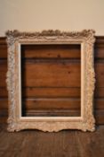 A painted wood and gesso picture frame with slip. H.80 W.70cm