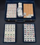 A Mah-jong set in fitted carrying case with lift out trays labelled Gino Ferrari. H.9 W.32cm