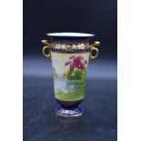 A Noritake twin handled vase in blue glaze with hand gilded and painted decoration with maker's mark