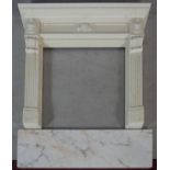 A faux polished marble fire surround in the Classical style with floral decorated frieze and