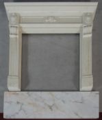 A faux polished marble fire surround in the Classical style with floral decorated frieze and