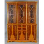 A Georgian style triple section library bookcase with astragal glazed doors enclosing book shelves