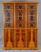 A Georgian style triple section library bookcase with astragal glazed doors enclosing book shelves