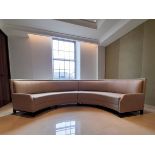 A large contemporary two section arc shaped banquette sofa in calico upholstery. 460cm, length of