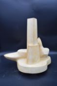 A cast plaster abstract modernist sculpture. H.46 W.46 D.26cm