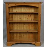 A Victorian style pine open bookcase on shaped bracket supports. H.120 W.99 D.31.5cm