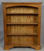 A Victorian style pine open bookcase on shaped bracket supports. H.120 W.99 D.31.5cm