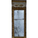 A 19th century carved giltwood and gesso full height pier mirror with painted architectural pediment