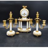 A French neoclassical style clock garniture in gilt metal and marble with a pair of three branch