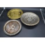 An eastern pierced metal bowl on tripod feet along with two other metal plates. H.6 Dia.35cm (with