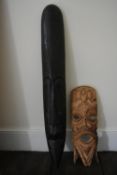 A carved tribal mask and another similar example. H.100 W.15cm (largest)