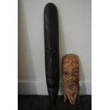 A carved tribal mask and another similar example. H.100 W.15cm (largest)