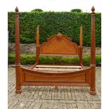 A large American Colonial style elm four poster bedstead with fluted column and spiral finials, to