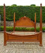A large American Colonial style elm four poster bedstead with fluted column and spiral finials, to