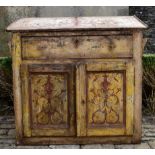 A 19th century French bureau with fall front above panel doors with all over scrolling hand