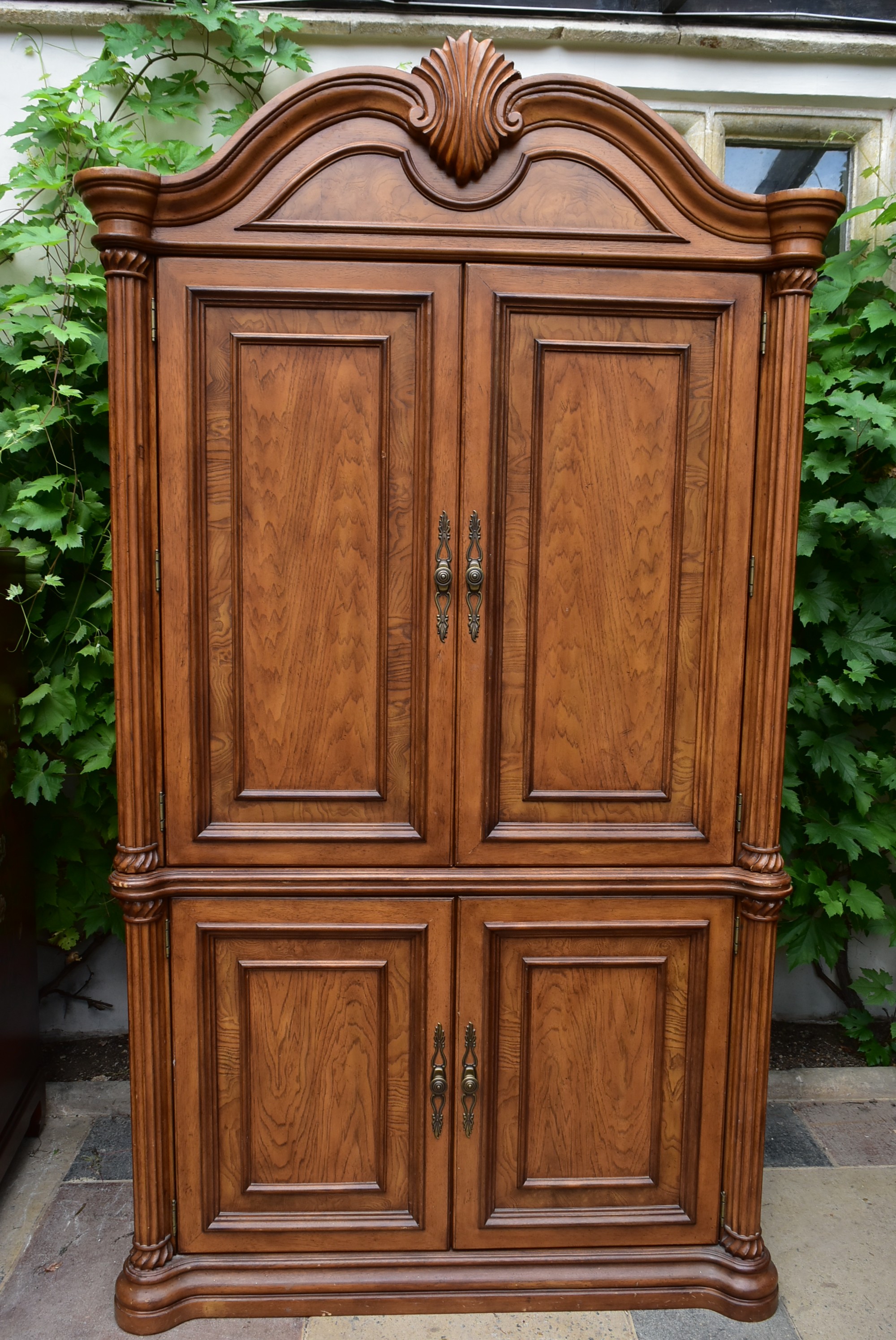 An American Colonial style elm four door cabinet enclosing fitted drawers. H.210 W.120 D.46cm