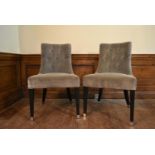 A pair of contemporary nursing chairs in buttoned velour upholstery on square tapering ebonised