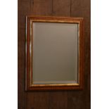 A wall mirror in gilt and painted frame with bevelled plate. H.50 W.38cm