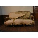 An 18th century Italian giltwood three seater canape in it's original and distressed upholstery