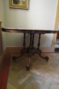 A mid 19th century burr walnut quarter veneered tilt top dining table on quadruped carved and