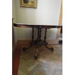 A mid 19th century burr walnut quarter veneered tilt top dining table on quadruped carved and