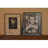 A pair of framed photographic portraits, one of Cary Grant. H.31 W.24cm (largest) (2)