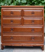 A Chinese carved hardwood chest of drawers with an arrangement of four short above two long