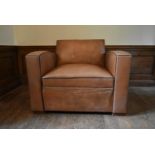 A vintage French leather upholstered armchair converting to single mattress base. H.81 W.106 D.