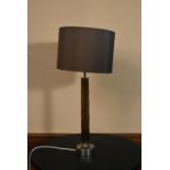 A contemporary chrome table lamp with twisted column and matching shade. H.63 W.29cm