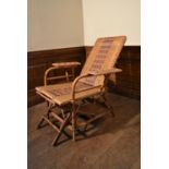 A vintage bamboo framed and rattan woven folding veranda armchair fitted with slide out foot rest.