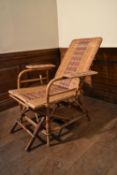 A vintage bamboo framed and rattan woven folding veranda armchair fitted with slide out foot rest.