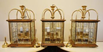 A set of three contemporary brass and oak framed ceiling lanterns in the 19th century style each