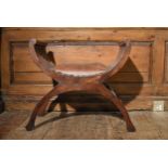 A contemporary teak X framed stool in leather upholstery. H.60 W.56 D.37cm