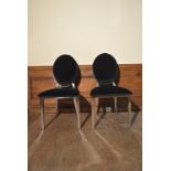 A pair of contemporary chrome framed dining chairs with upholstered backs and seats. H.94 W.45cm